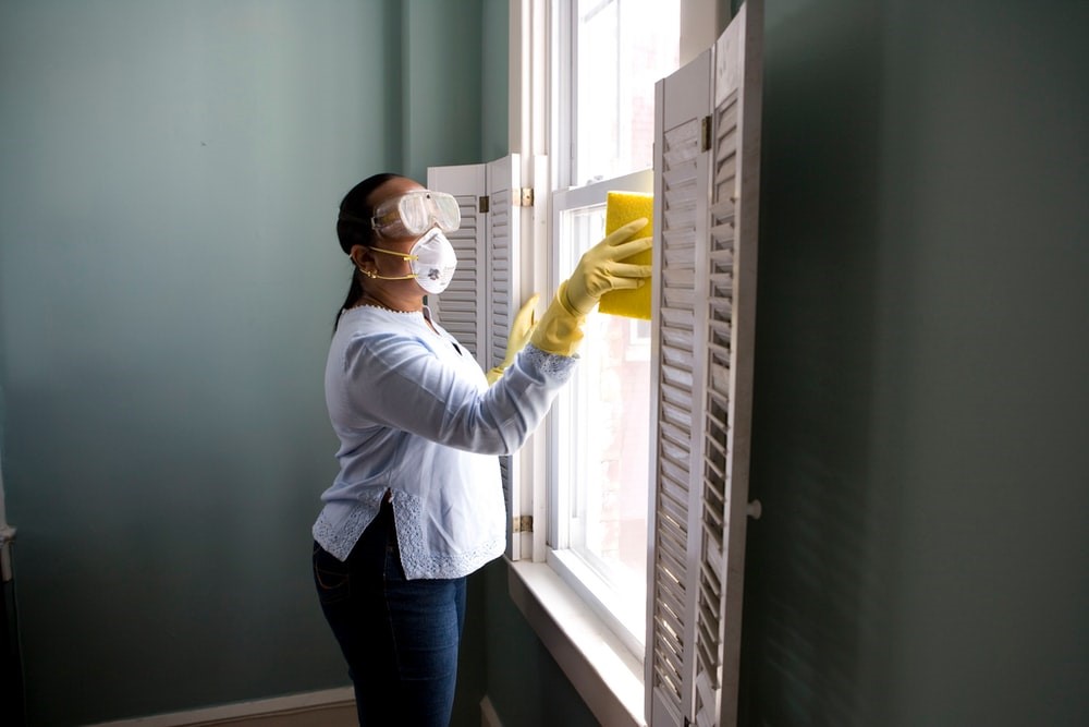 A woman disinfecting her house of coronavirus germs.
