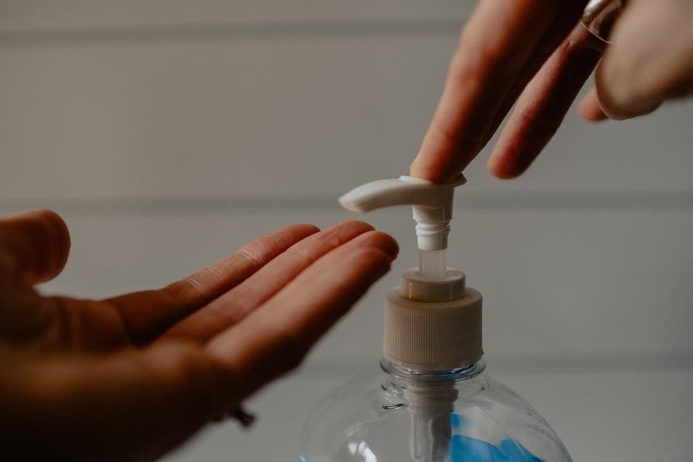 A person using a hand sanitizer